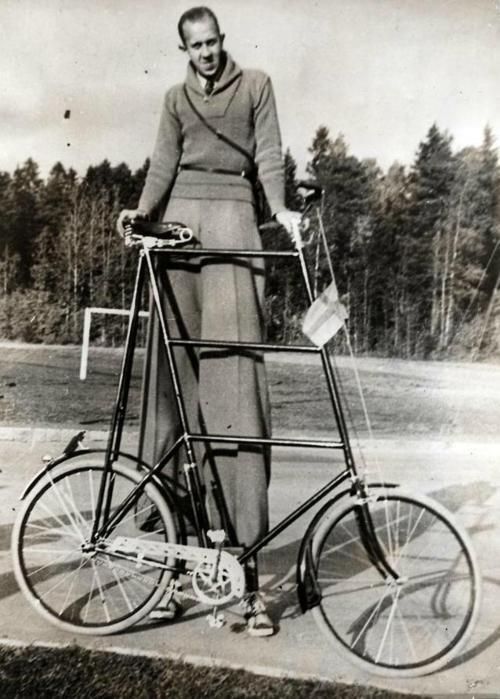 Skinny tall guy with tall bike