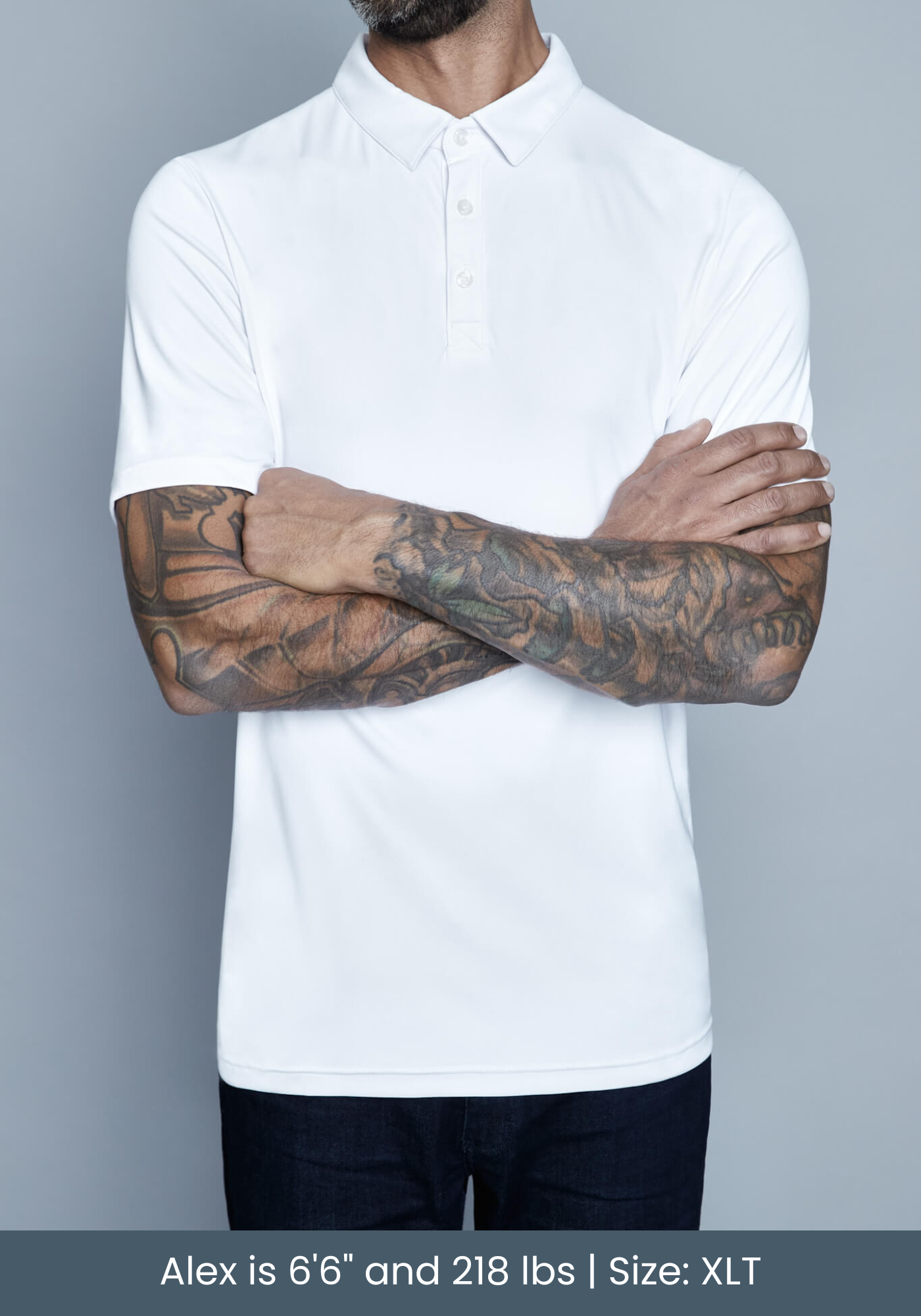 tall model wearing mens polo shirt in studio with tattoos.