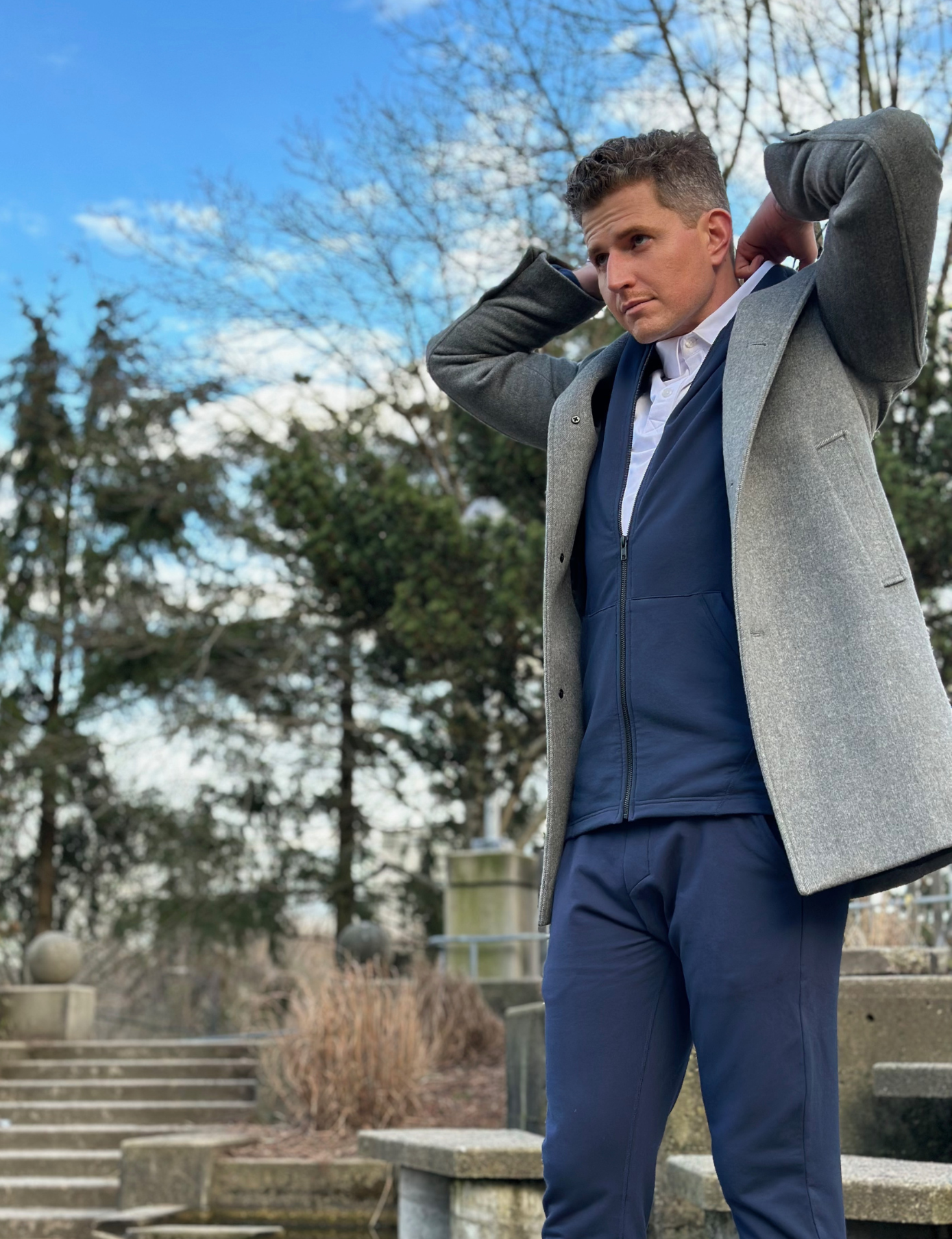 tall guy dan wearing navas lab navy hoodie and joggers with grey blazer