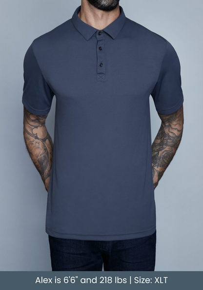 tall model wearing mens polo shirt in studio with tattoos.