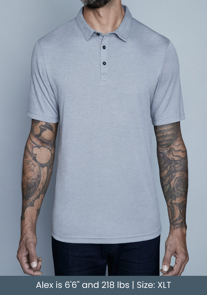 tall model wearing mens polo shirt in studio with tattoos.