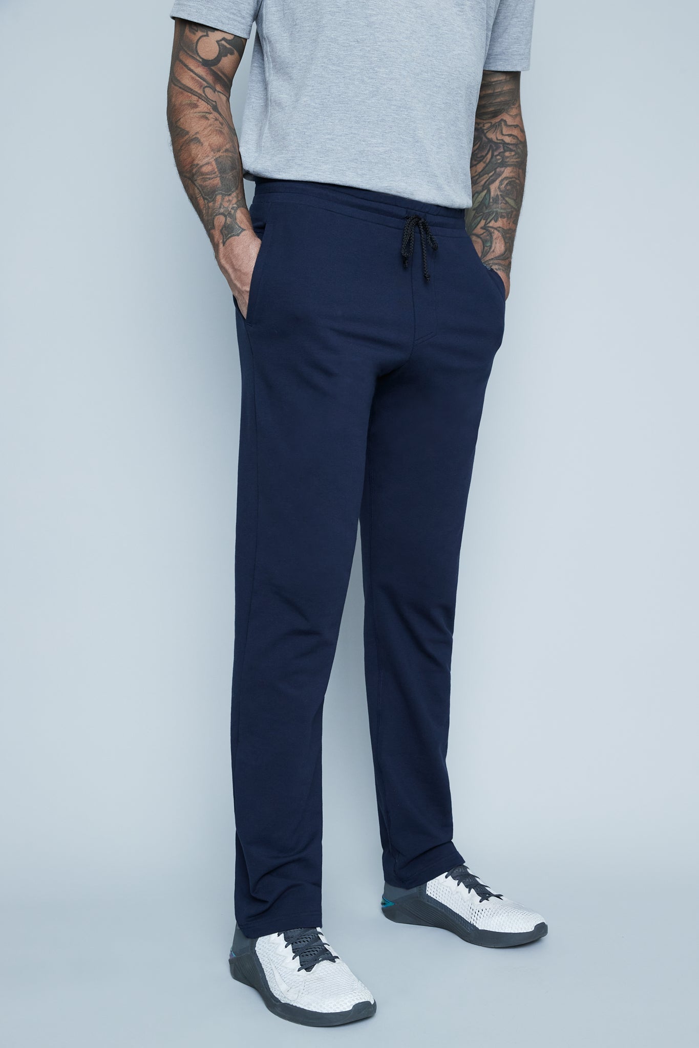 navy lounge pants on tall male model in studio