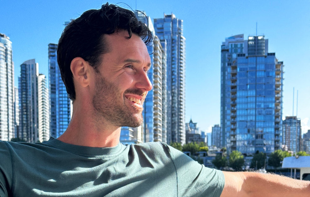 paul marlow wearing a green shirt in front of tall buildings in yaletown, vancouver